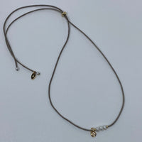 Tan string w 3 mini pearls and moon charm