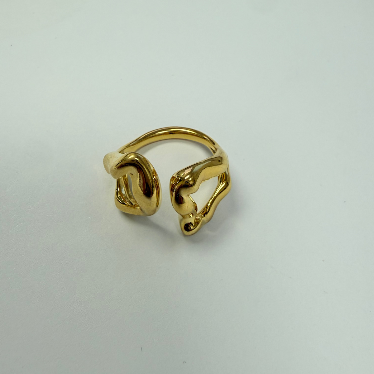 Gold ring on a light gray background
