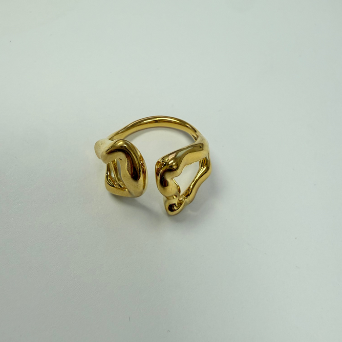 Gold ring on a light gray background